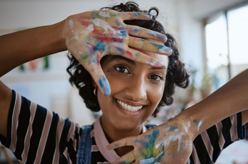 Happy person with paint on their hands