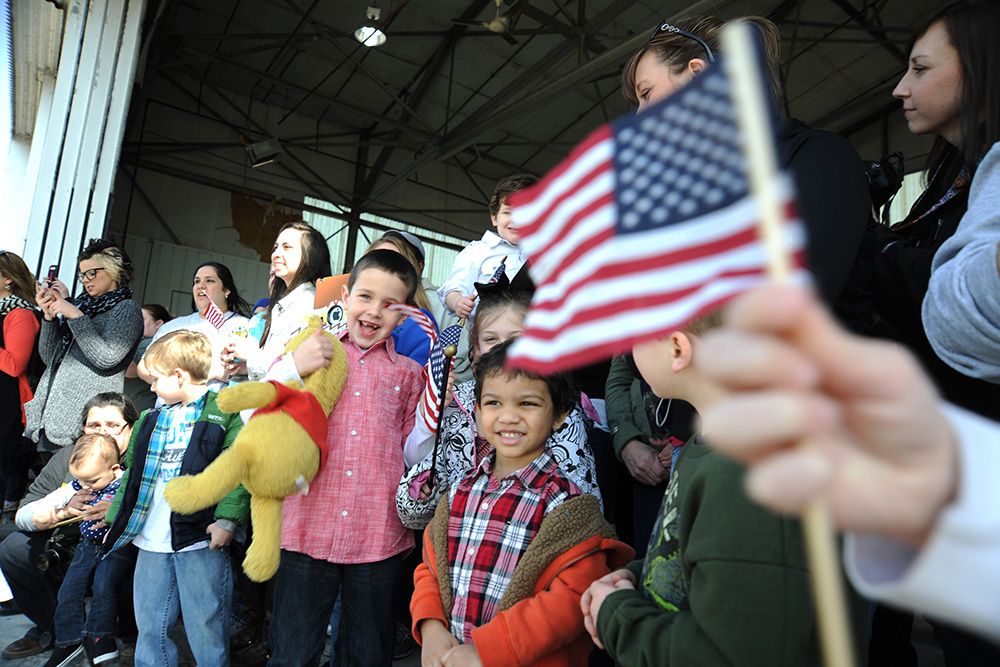 People greeting returning service members